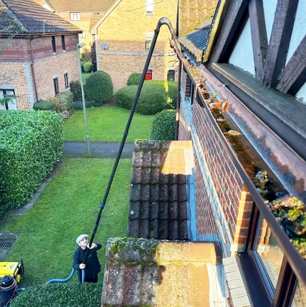 Close up of gutter cleaning with pole fed goose neck system.