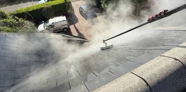 Slate roof being cleaned close up.