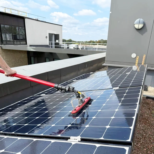 Solar panel cleaning in process with pole fed system.