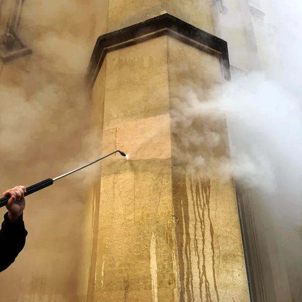 Stone cleaning historic building.